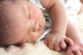 Cute newborn tiny Asian baby sleeping on the bed Royalty Free Stock Photo