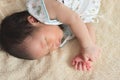 Cute newborn tiny Asian baby sleeping on the bed Royalty Free Stock Photo