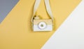 Cute nice small wooden camera on gray yellow white background. Eco accessories, toys for newborn, baby. Flat lay