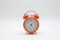 Orange color alarm clock with white background
