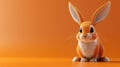 Cute orange rabbit sitting attentively on an orange background.