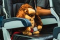 Cute orangutan doll passenger of airplane sitting in comfortable seat - Traveler or vacation concept