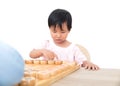 The cute oriental girl is seriously playing Chinese chess with her opponent Royalty Free Stock Photo