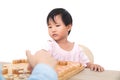 The cute oriental girl is seriously playing Chinese chess with her opponent Royalty Free Stock Photo