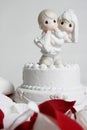Cute Ornament Of Groom Carrying Bride On Top Of Wedding Cake
