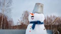 Cute outdoor snowman. Snowy new year`s Christmas fun