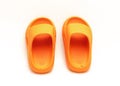 Cute pair of orange pillow slide sandals for toddler non-slip foam slippers isolated on white Royalty Free Stock Photo