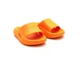 Cute pair of orange pillow slide sandals for toddler non-slip foam slippers isolated on white Royalty Free Stock Photo