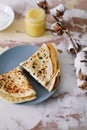 Stack of delicious homemade pancakes on plate with honey, sour cream and tea. Breakfast. Rustic style, close up top view. Flat lay Royalty Free Stock Photo