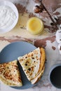 Stack of delicious homemade pancakes on plate with honey, sour cream and tea. Breakfast. Rustic style, close up top view. Flat lay Royalty Free Stock Photo