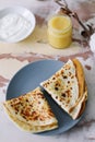 Stack of delicious homemade pancakes on plate with honey, sour cream and tea. Breakfast. Rustic style, close up top view. Flat lay Royalty Free Stock Photo