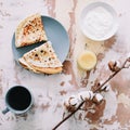 Stack of delicious homemade pancakes on plate with honey, sour cream and tea. Breakfast. Rustic style, close up top view. Flat lay Royalty Free Stock Photo