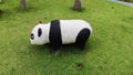 Cute panda statue eating grass in the garden