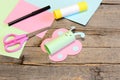 Cute paper butterfly crafts, scissors, marker, glue stick, colored paper set, pencil on old wooden table. Kids working place