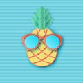 Cute paper pineapple in sunglasses on striped background.