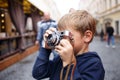 Cute photographer boy holding old film camera Royalty Free Stock Photo