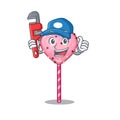 A cute picture of candy heart lollipop working as a Plumber