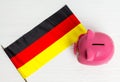 cute pig money box and Germany flag - save money in Germany concept. view from above Royalty Free Stock Photo