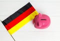 cute pig money box and Germany flag - save money in Germany concept. view from above Royalty Free Stock Photo