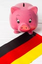 cute pig money box and Germany flag - save money in Germany concept. Vertical Royalty Free Stock Photo