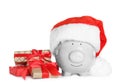 Cute piggy bank with Santa hat and Christmas gifts Royalty Free Stock Photo