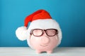 Cute piggy bank with Santa hat and glasses Royalty Free Stock Photo