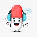 Cute pill mascot listening to music Royalty Free Stock Photo