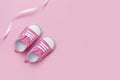 Cute pink baby girl sneakers close up on pink background