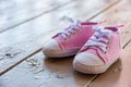 Cute pink baby girl sneakers close up outside