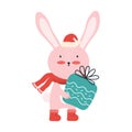 Cute pink baby rabbit in Santa hat with a big gift box. Christmas funny cartoon animal isolated on a white background Royalty Free Stock Photo
