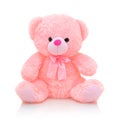 Cute pink bear doll with bow on white background with shadow reflection. Playful bright pink bear.