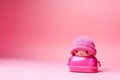 Cute pink doll keychain for bag on pink background