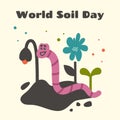 Cute pink earthworm crawling in ground and cleaning soil. World soil day. Color Fresh foliage, flower. Soil fertility and