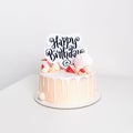 Beautiful pink birthday cake for a girl decorated with sweet candies with white background Royalty Free Stock Photo