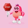 Cute pink monster holding stop sign, street sign, road sign Royalty Free Stock Photo