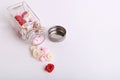 Cute pink, red, white and cream flowers in a glass jar on a White background Royalty Free Stock Photo