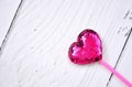 Cute , pink , shining heart shape gift made of sequins on valentine day on white wooden background