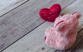 Cute pink Teddy bear looks at red heart ` I Love You `