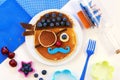 Cute pirate pancakes with blueberry. Creative idea for children breakfast.