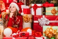 cute playful christmas elf. little girl red santa hat. santa claus residence. present delivery service. too much gifts Royalty Free Stock Photo