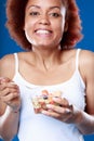 Cute playful young Black woman eating fruit salad Royalty Free Stock Photo