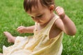 Cute, playing and girl baby on grass having fun in backyard, park or garden for youth. Nature, sweet and kid, infant or Royalty Free Stock Photo