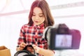 Cute pleasant little schoolgirl feeling busy while filming her new blog