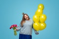 Cute plump woman with balloons and bouquet Royalty Free Stock Photo