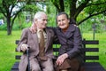 Cute 80 plus year old married couple posing for a portrait in their garden. Love forever concept