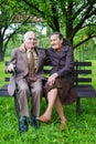 Cute 80 plus year old married couple posing for a portrait in their garden. Love forever concept