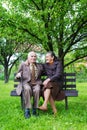 Cute 80 plus year old married couple posing for a portrait in their garden. Love forever concept