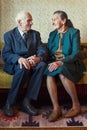 Cute 80 plus year old married couple posing for a portrait in their house. Love forever concept Royalty Free Stock Photo