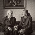 Cute 80 plus year old married couple posing for a portrait in their house. Love forever concept. Royalty Free Stock Photo