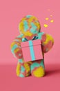 Cute plush rainbow Yeti with gift box hearts 3d rendering Valentines day pink background Contemporary advertising banner